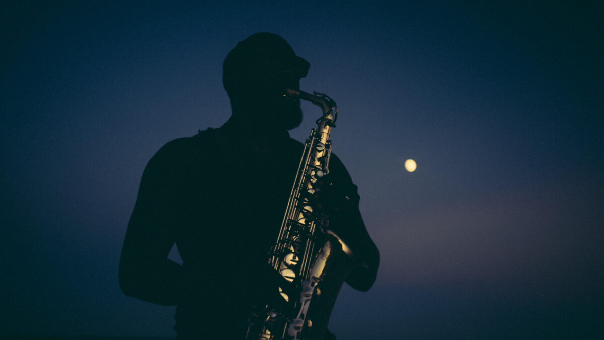 A saxophonist at sunset.
