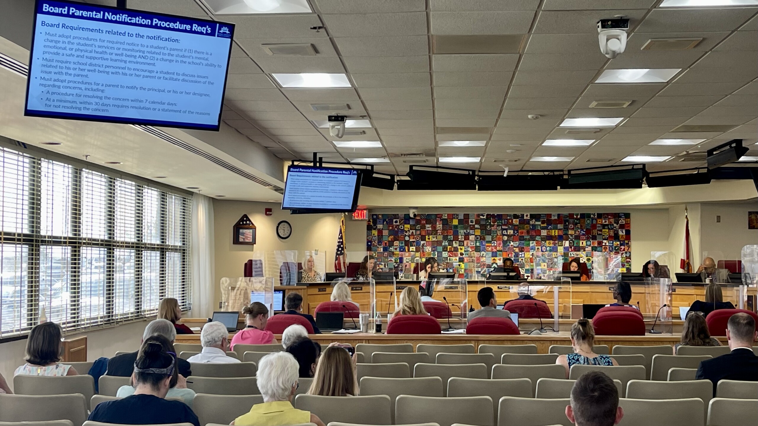 About 2 dozen people are seated in the audience at Duval County Public Schools auditorium. School board members are reviewing a slide that outlines new procedures for parental notification, in response to Florida's new "Parental Rights in Education Law."