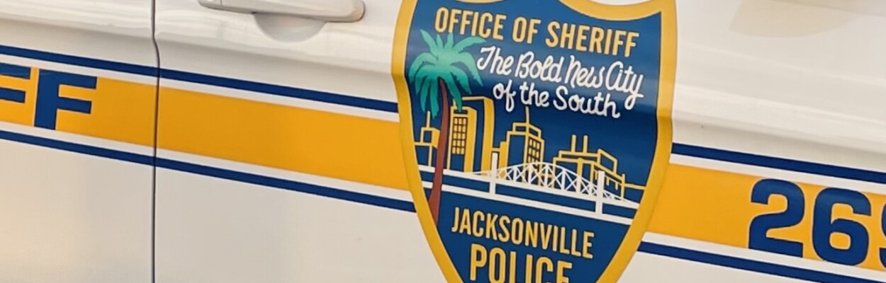 A close-up of a Jacksonville Sheriff's Office patrol car, with a crest that reads "Office of the Sheriff, The Bold New City of the South"