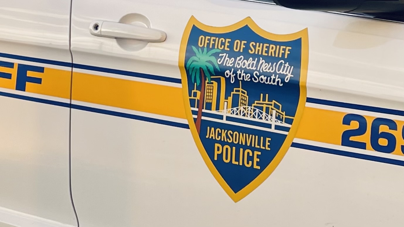 A close-up of a Jacksonville Sheriff's Office patrol car, with a crest that reads "Office of the Sheriff, The Bold New City of the South"