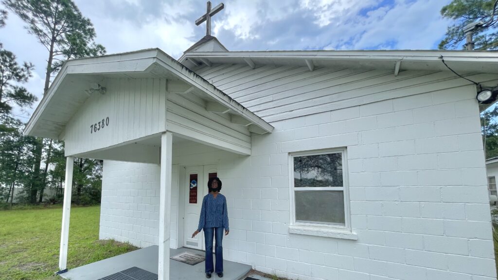 Church elder Gloria Thomas in front of Harper Chapel Baptist Church in Piney. | Claire Heddles, Jacksonville Today