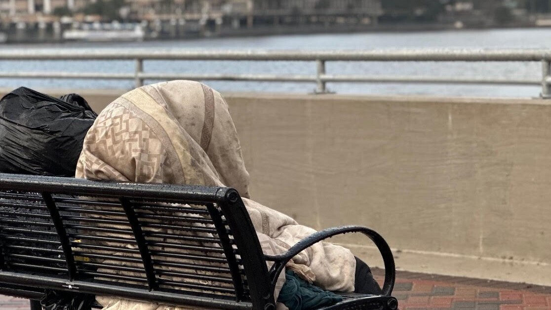 A homeless person covers up from the cold in Downtown Jacksonville.