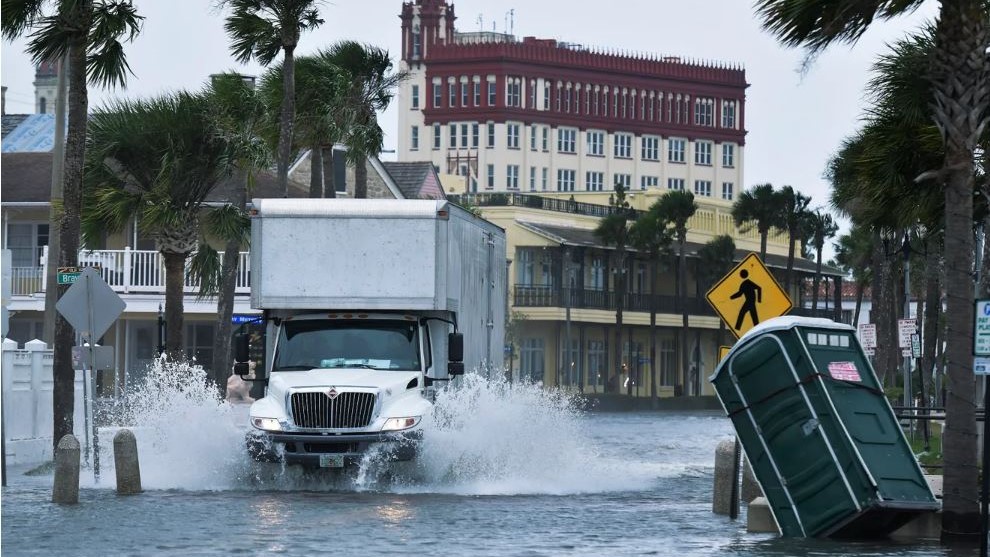 A truck plows through floodwaters in St. Augustine.