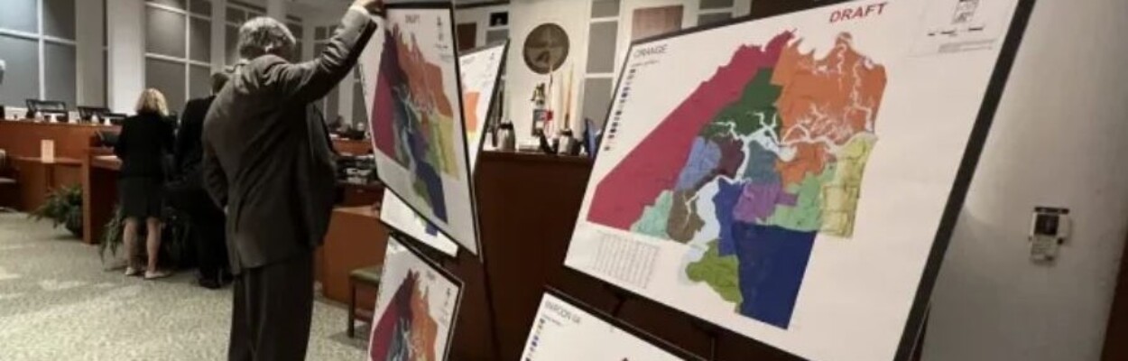 Then-General Counsel Jason Teal sets up proposed maps at a redistricting meeting after a federal court ordered the Jacksonville City Council to redraw its district maps. | Andrew Pantazi, The Tributary