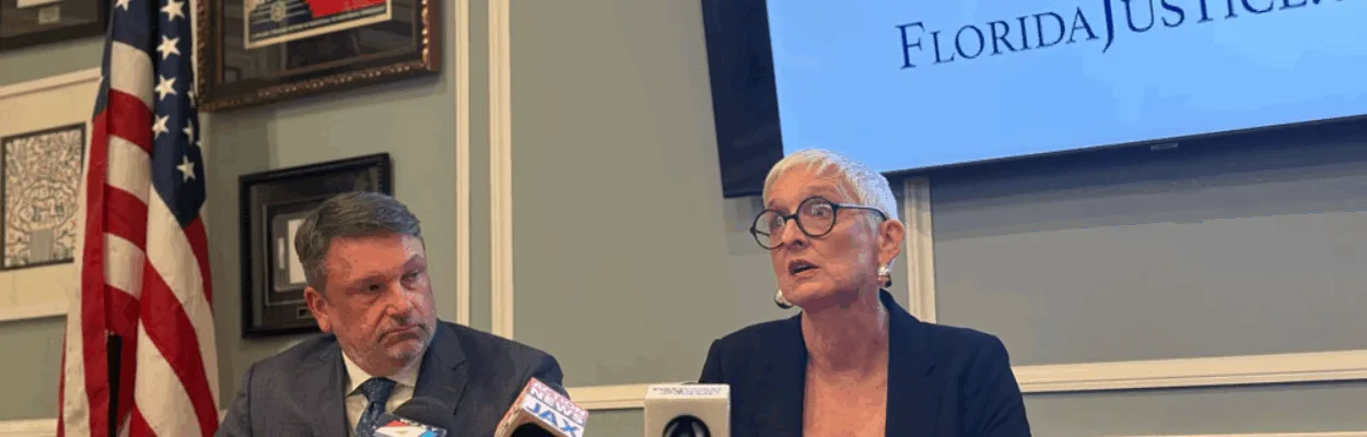 Hope McMath and her attorney, John Phillips, sit at a table with three microphones as they talk about updates in the case against her teaching license.
