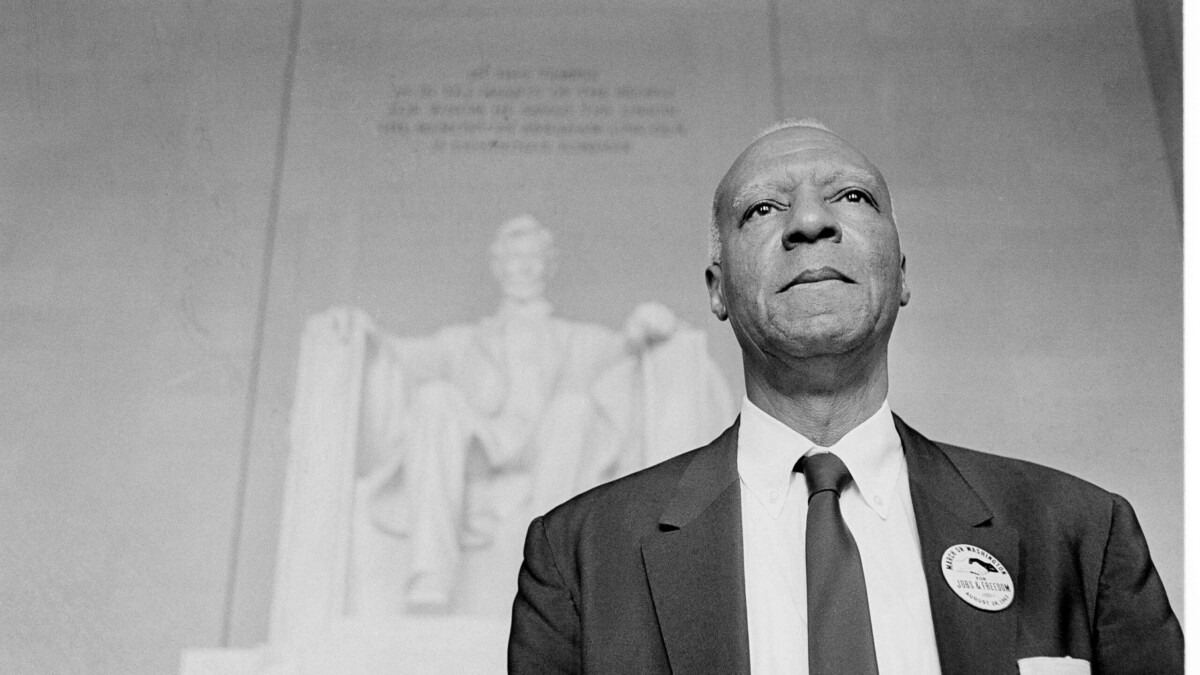 A. Philip Randolph, one of the chairmen for the March On Washington, stands in front of the statue of Abraham Lincoln at the Lincoln Memorial after a parade through the streets of the capital, Aug. 28, 1963.