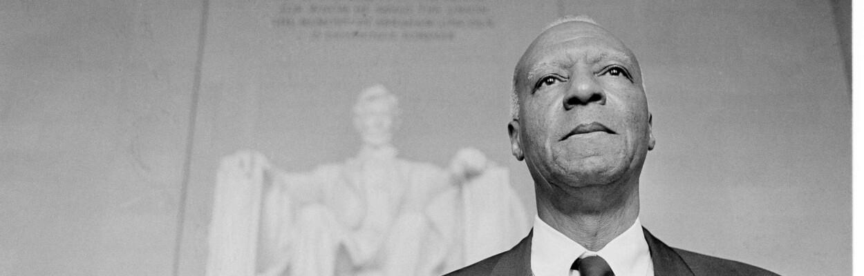 A. Philip Randolph, one of the chairmen for the March On Washington, stands in front of the statue of Abraham Lincoln at the Lincoln Memorial after a parade through the streets of the capital, Aug. 28, 1963.