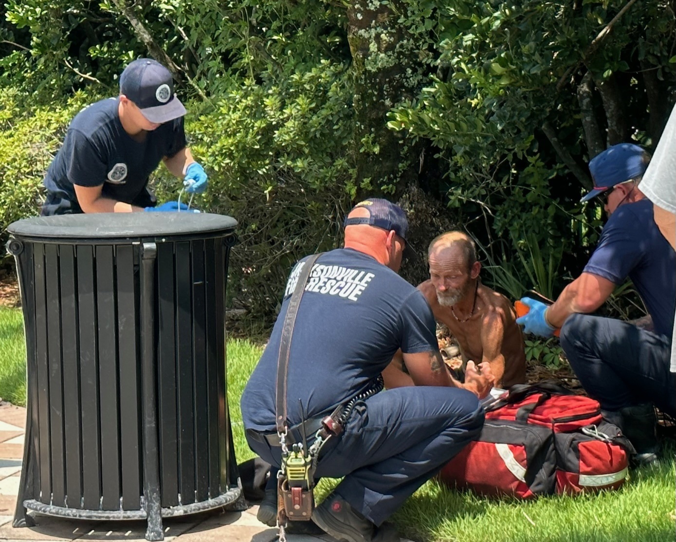 Jacksonville Fire and Rescue personnel help a man as the temperature hits 94 degrees on Aug. 1, 2023.
