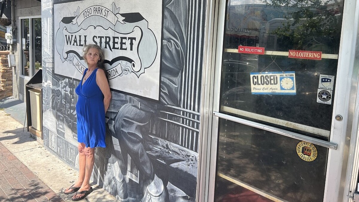 Janie Pearl “JP” Canova stands outside the Wall Street Deli & Lounge, where she has worked since 1995.