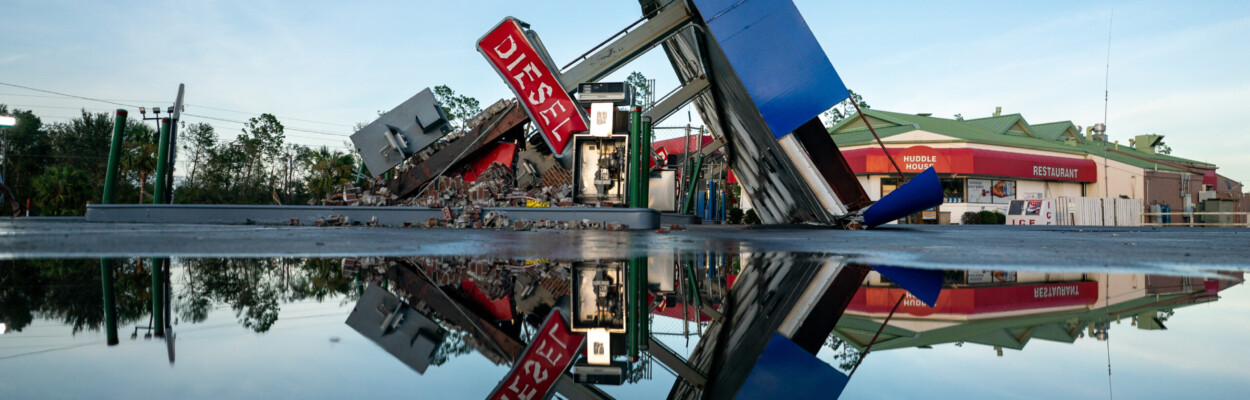 A storm-damaged gas station is reflected in a puddle after Hurricane Idalia crossed the state on Thursday, Aug. 30, 2023, in Perry.