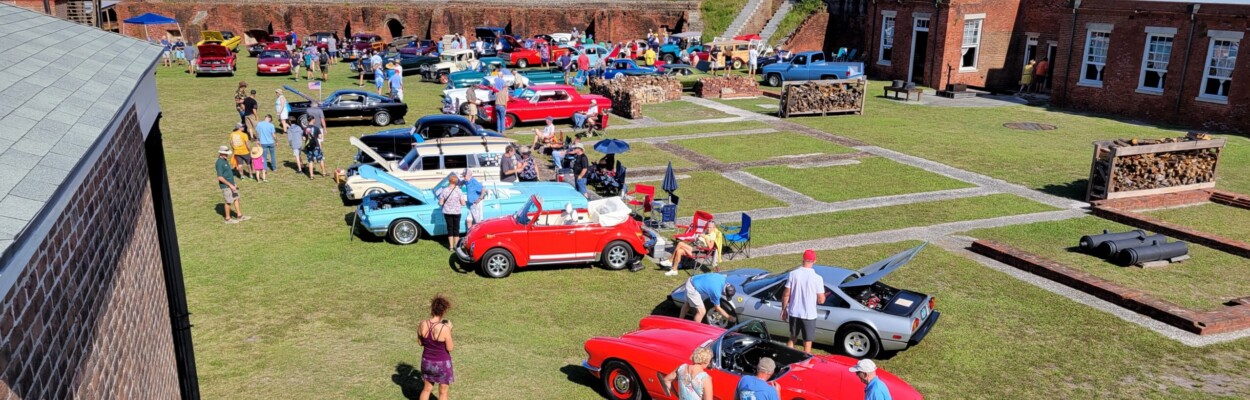 Classic cars are arrayed under cannons that ring Fort Clinch during the annual fundraising car show.