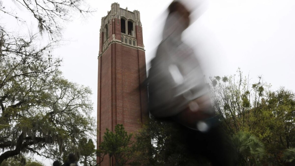 Students walk by Century Tower on the University of Florida campus in Gainesville.
