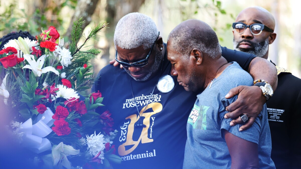 Kenneth Nunn, left, and Benjamin L. Crump mourn for the victims of the Rosewood massacre during a wreath-laying ceremony, at Rosewood on Jan. 8, 2023. | Xinyue Li, Fresh Take Florida