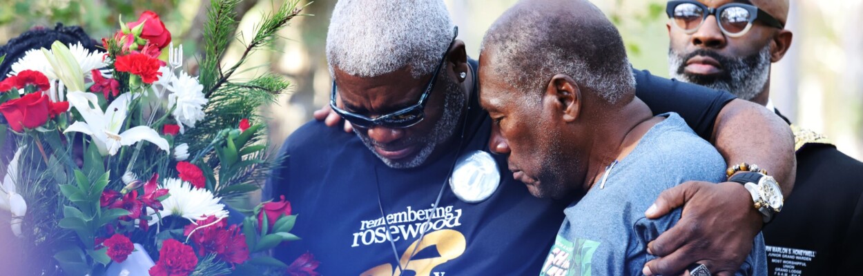 Kenneth Nunn, left, and Benjamin L. Crump mourn for the victims of the Rosewood massacre during a wreath-laying ceremony, at Rosewood on Jan. 8, 2023. | Xinyue Li, Fresh Take Florida