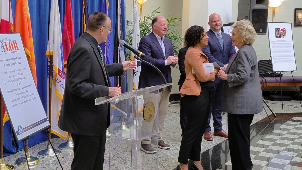 Suzie Loving, right, chief administrative officer of the Five Star Veterans Center, is greeted at a Celebration of Valor event Wednesday, Oct. 25, 2023. | Dan Scanlan, WJCT News 89.9