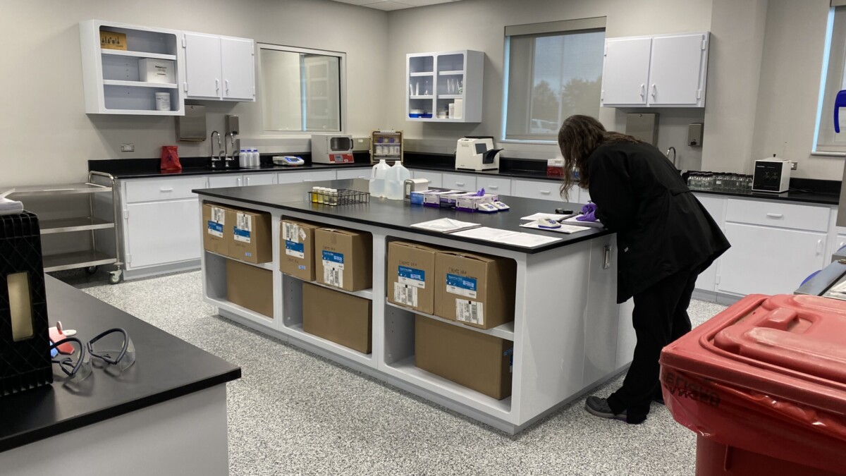 A lab worker reads samples taken at the new utility lab in St. Johns County l Steven Ponson, WJCT News 89.9