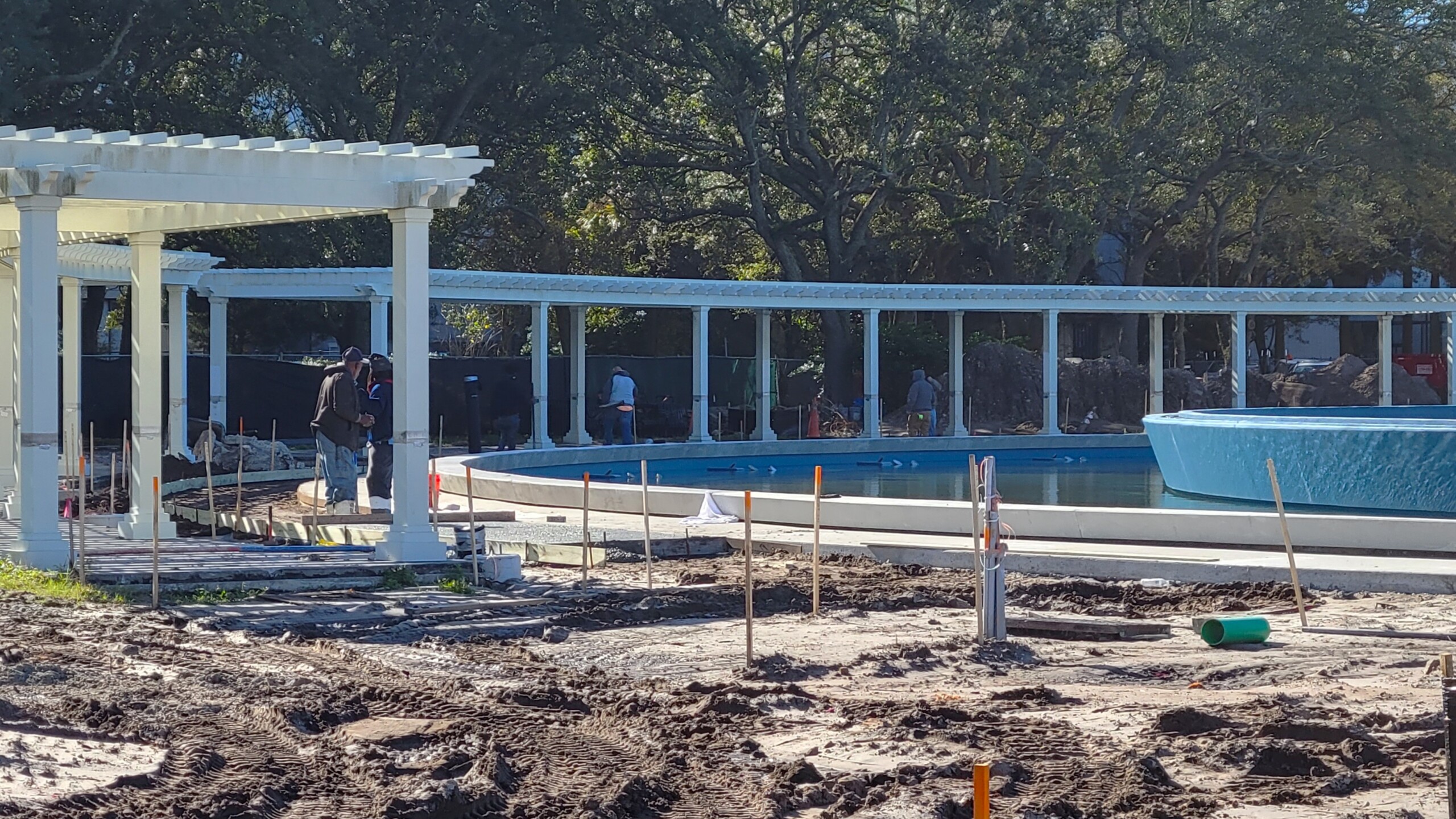 Workers manage sidewalk and walkway construction at Friendship Fountain on Tuesday, Dec. 19, 2023. | Dan Scanlan, WJCT News 89.9