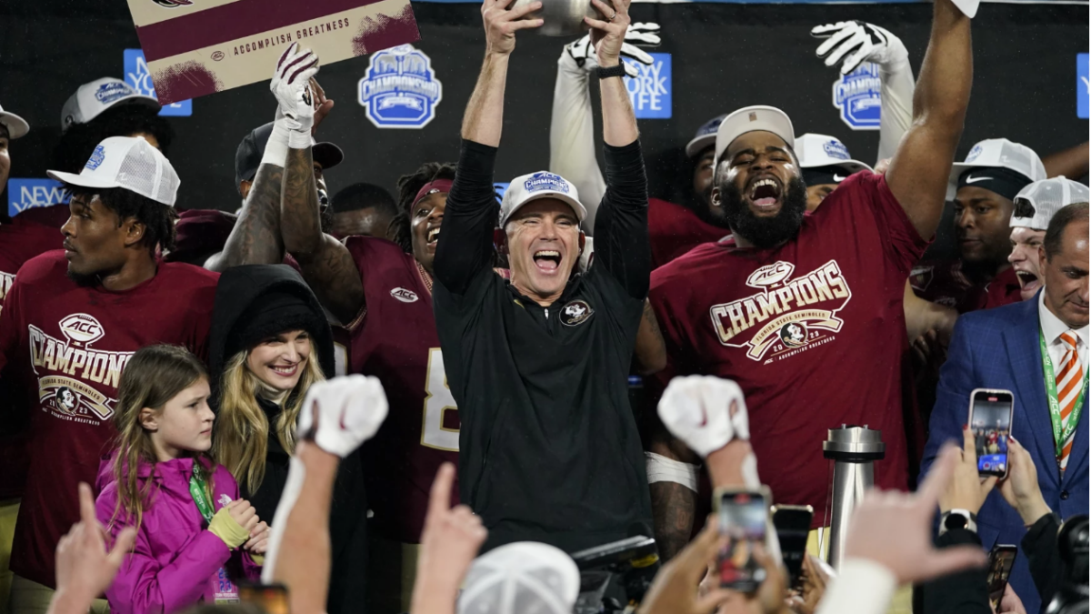 Florida State coach Mike Norvell lifts the trophy after the team's win over Louisville in the Atlantic Coast Conference championship game Dec. 2, 2023. | Erik Verduzco, AP