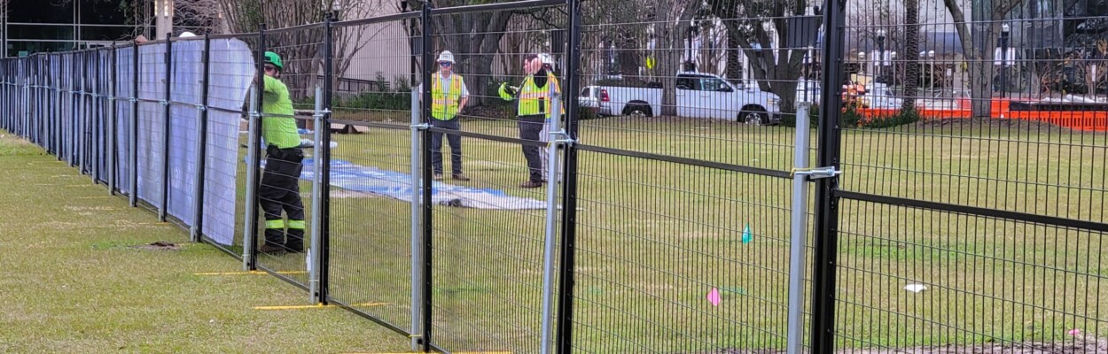 Contractors install construction fencing Friday around the city's planned Riverfront Plaza. | Dan Scanlan, WJCT News 89.9