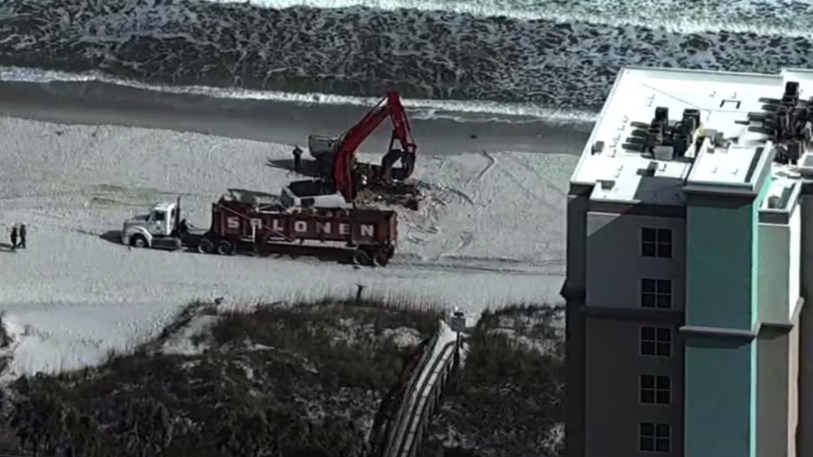 Crews work to demolish 40-foot sailboat that has been stranded on Jacksonville Beach since October. | Travis Gibson, News4Jax