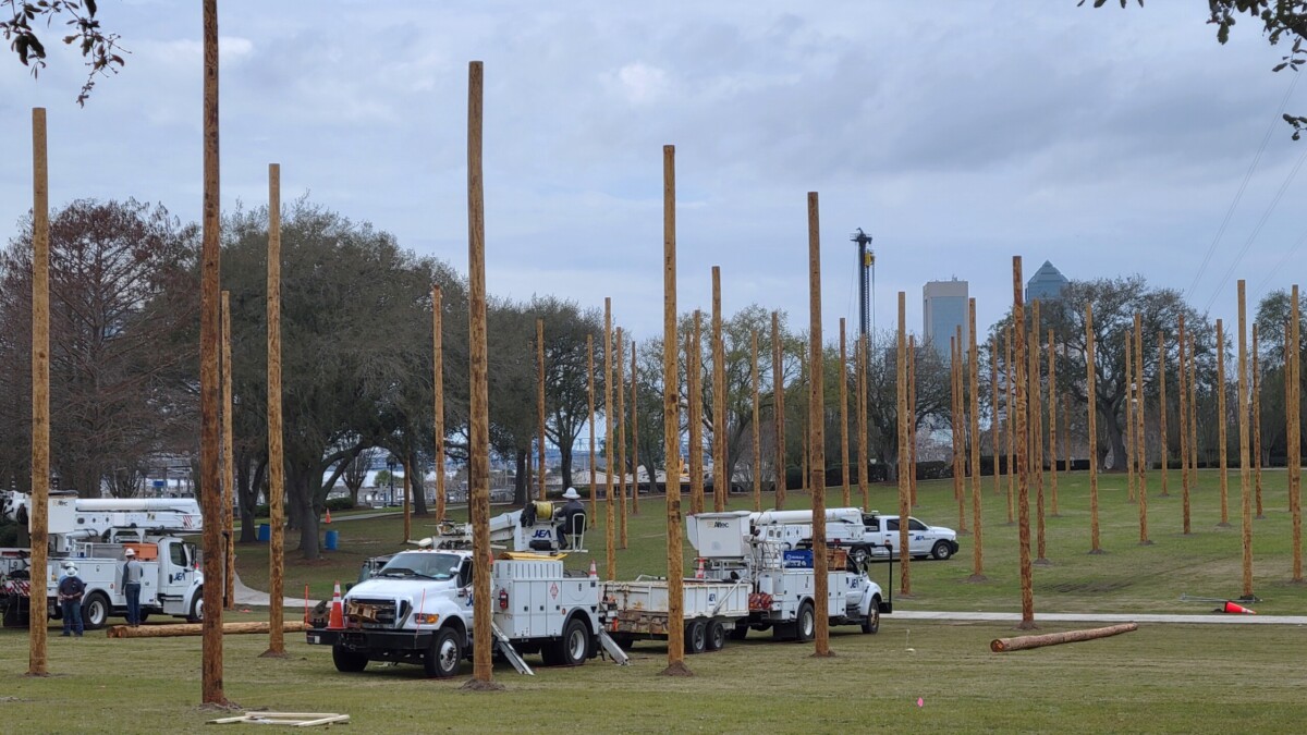 JEA crews install dozens of power poles Monday, Feb. 12, 2024, in Metropolitan Park in advance of this weekend's Florida Lineman Competition | Dan Scanlan, WJCT News 89.9