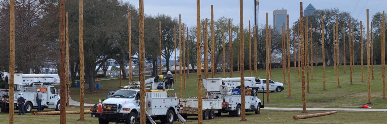 JEA crews install dozens of power poles Monday, Feb. 12, 2024, in Metropolitan Park in advance of this weekend's Florida Lineman Competition | Dan Scanlan, WJCT News 89.9