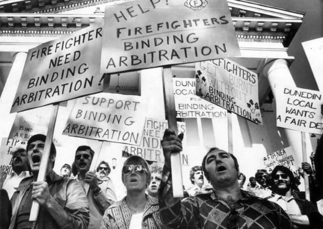 Firefighters hold signs calling for binding arbitration, in 1977 Tallahassee. Firefighters are not affected by SB 256. | Mark Foley, Florida Memory