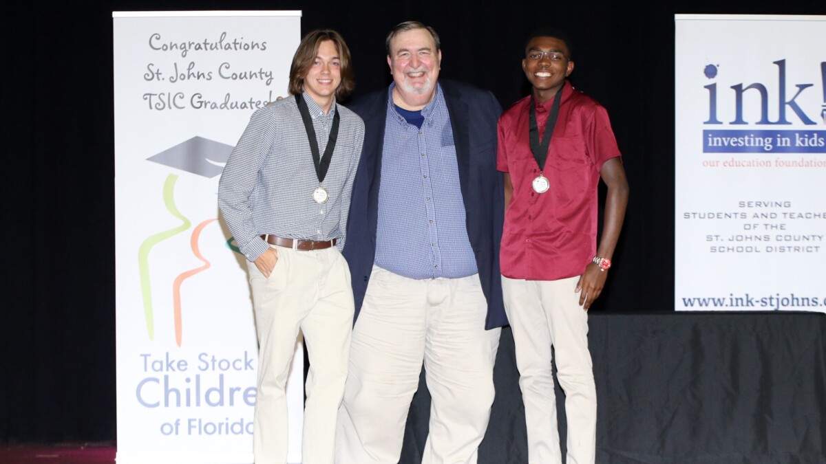 Graduating seniors Aidan Bryant, left, and Horace Taylor are shown in 2022 with James Wheeler, operations and student programs director for INK!