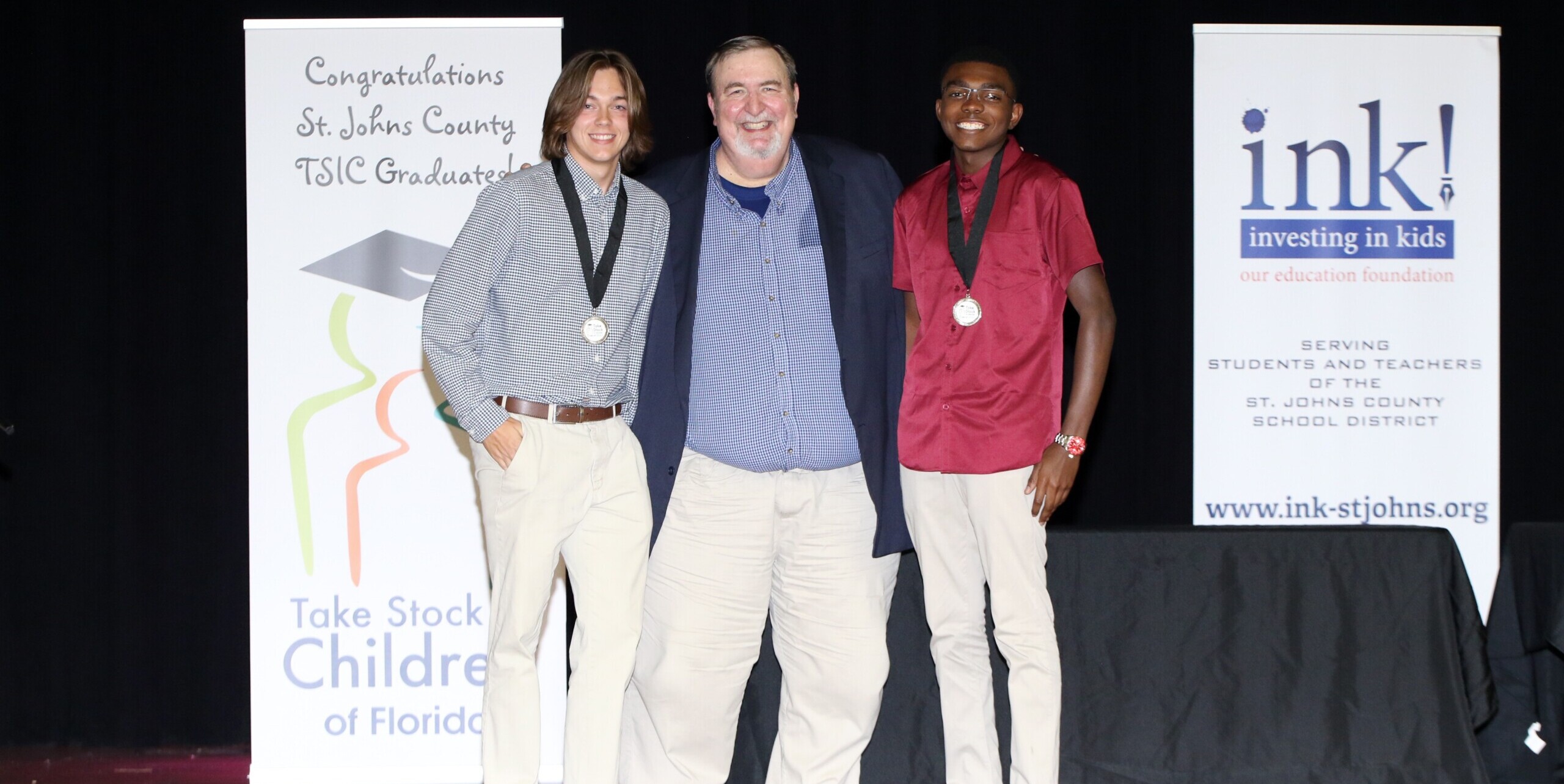Graduating seniors Aidan Bryant, left, and Horace Taylor are shown in 2022 with James Wheeler, operations and student programs director for INK!