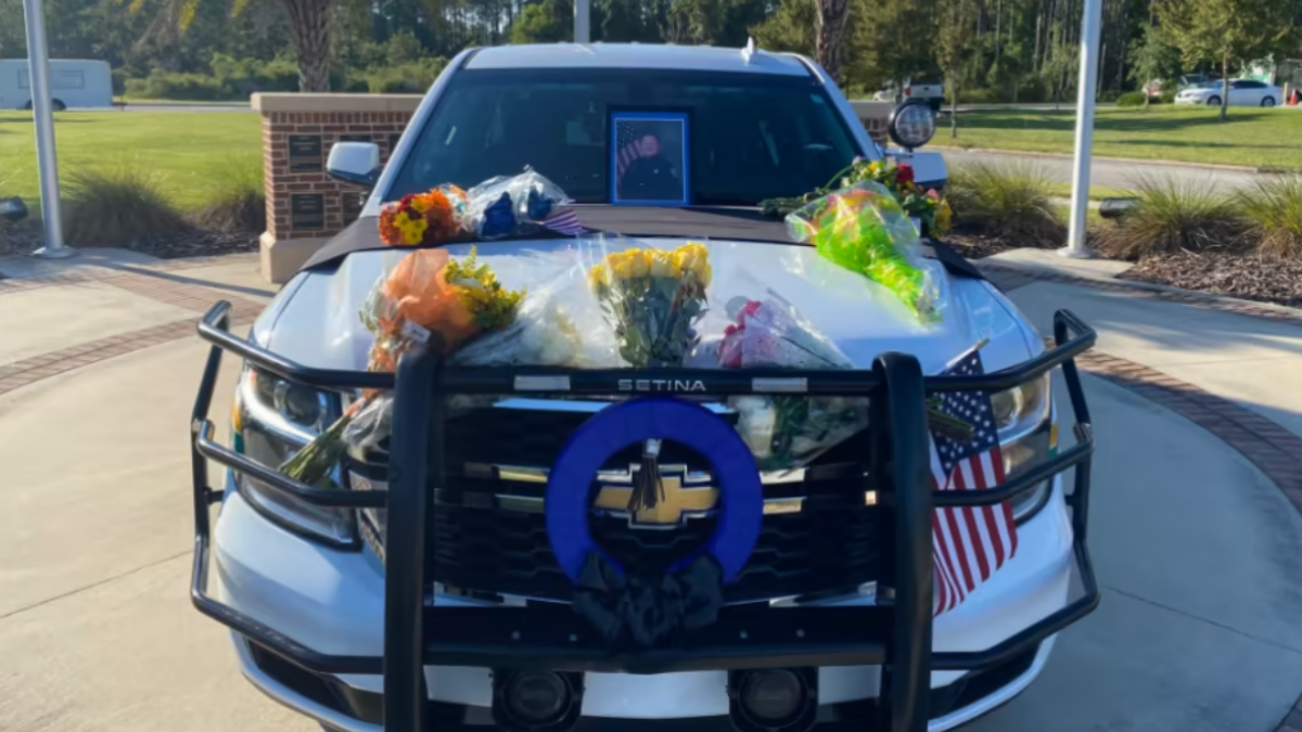 The cruiser of Nassau County Deputy Josh Moyers is decorated with memorial flowers and messages after his fatal shooting in 2021. | News4Jax