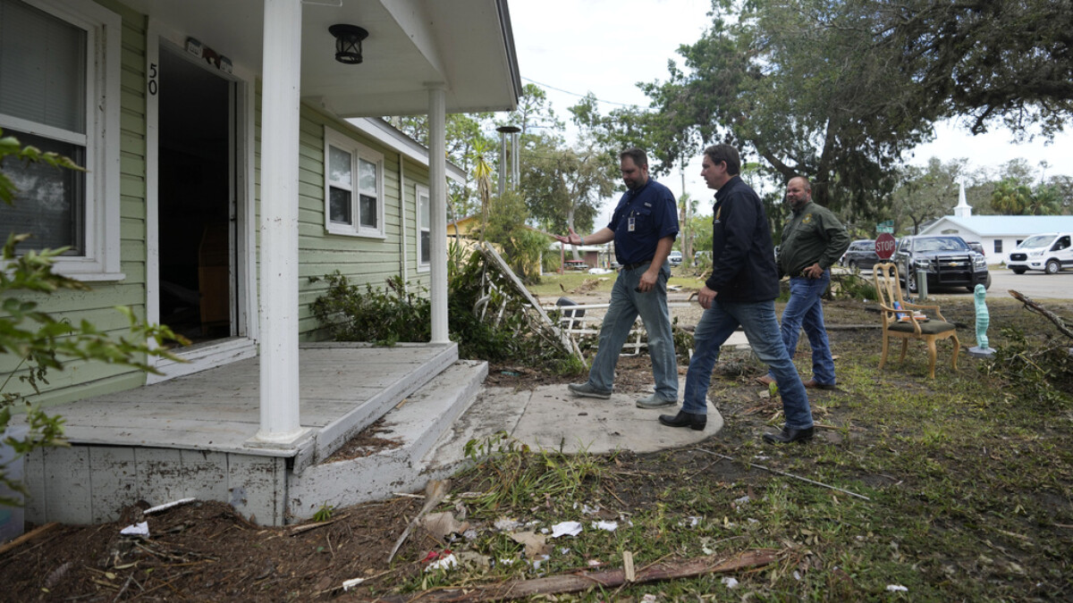 Florida Gov. Ron DeSantis, second from right, visits a home whose interior was heavily damaged by storm surge during the passage of Hurricane Idalia on Aug. 31, 2023, in Horseshoe Beach. | Rebecca Blackwell, AP