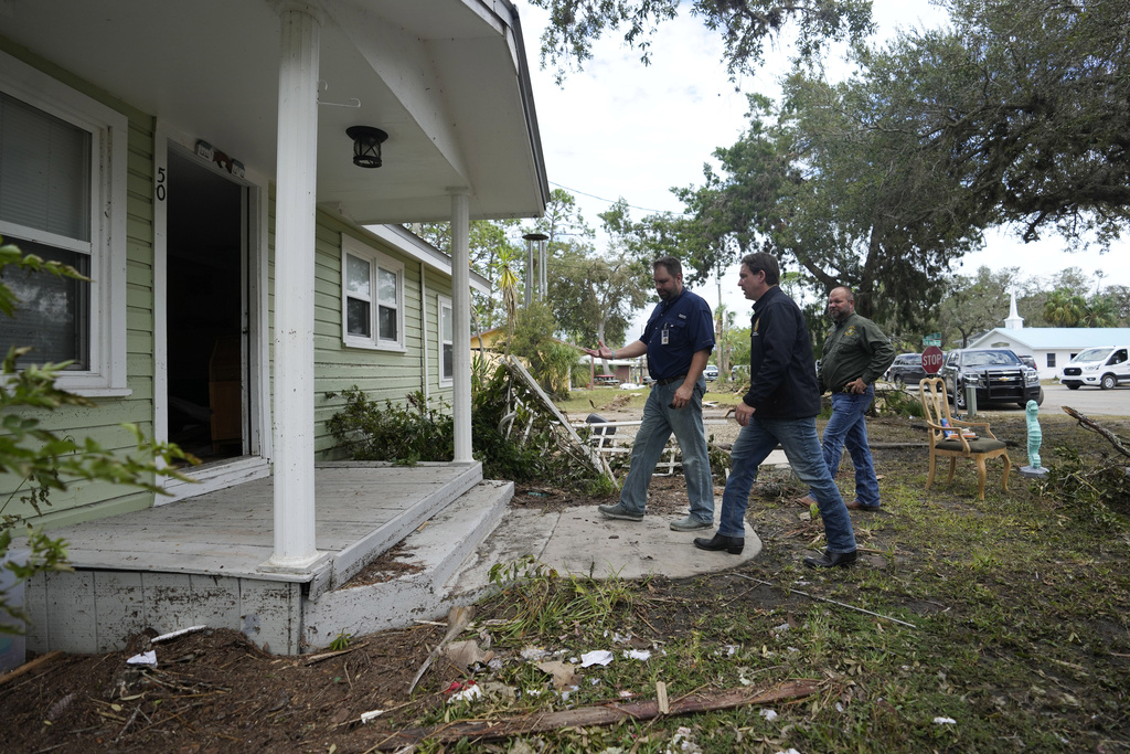 Florida Gov. Ron DeSantis, second from right, visits a home whose interior was heavily damaged by storm surge during the passage of Hurricane Idalia on Aug. 31, 2023, in Horseshoe Beach. | Rebecca Blackwell, AP