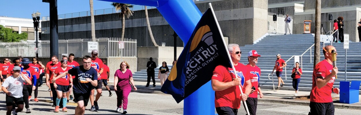 More than 100 law enforcement officers carry the Special Olympics “Flame of Hope” through Jacksonville on Tuesday, April 23, 2024. Chief Jonathan Barrier leads the way with the flame. | Dan Scanlan, Jacksonville Today