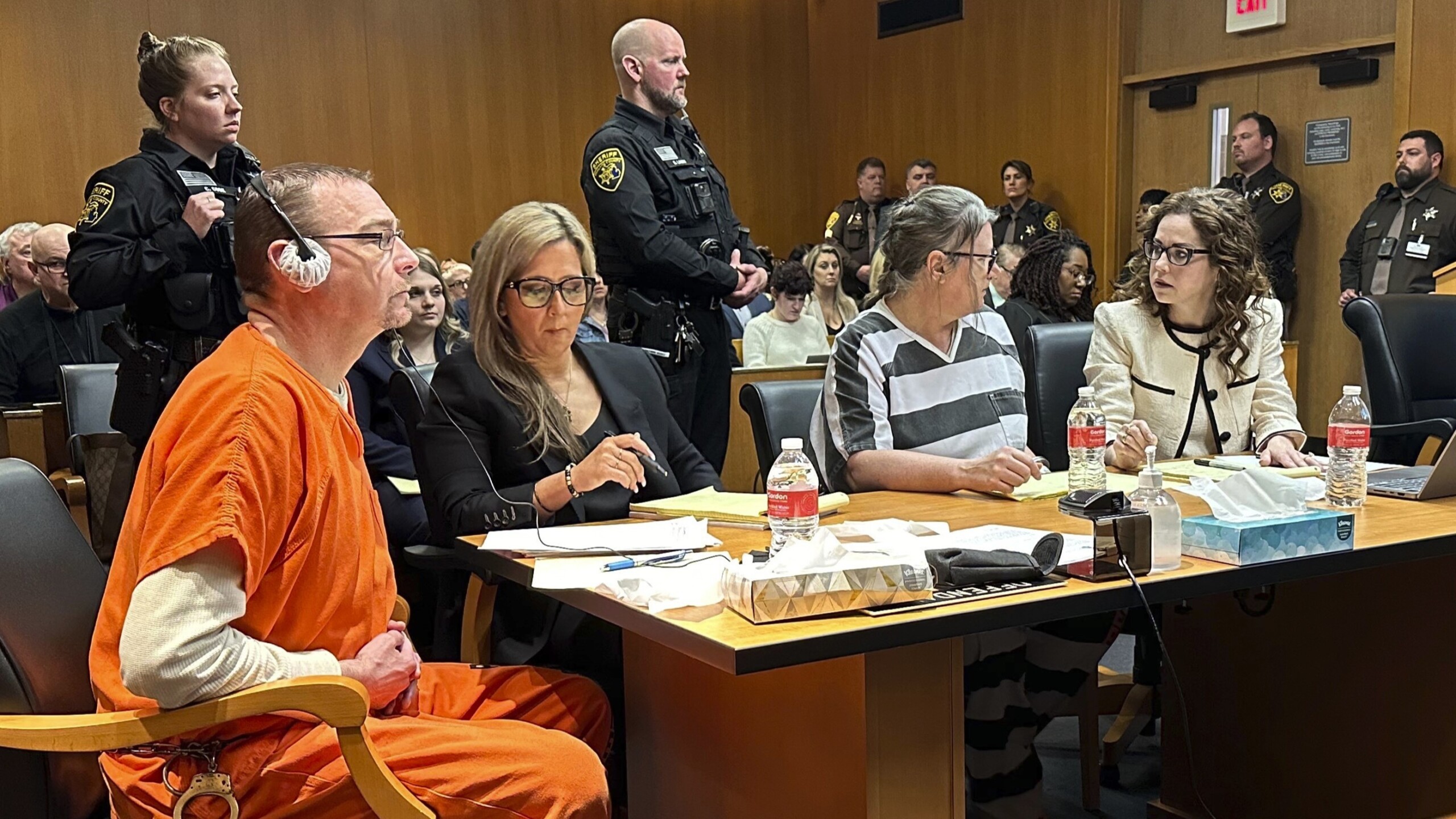 From left, James Crumbley, defense lawyer Mariell Lehman, Jennifer Crumbley and defense lawyer Shannon Smith await sentencing in Oakland County, Michigan, court on Tuesday, April 9, 2024. The Crumbleys were convicted of involuntary manslaughter for a school shooting committed by their son in 2021. | Ed White, AP