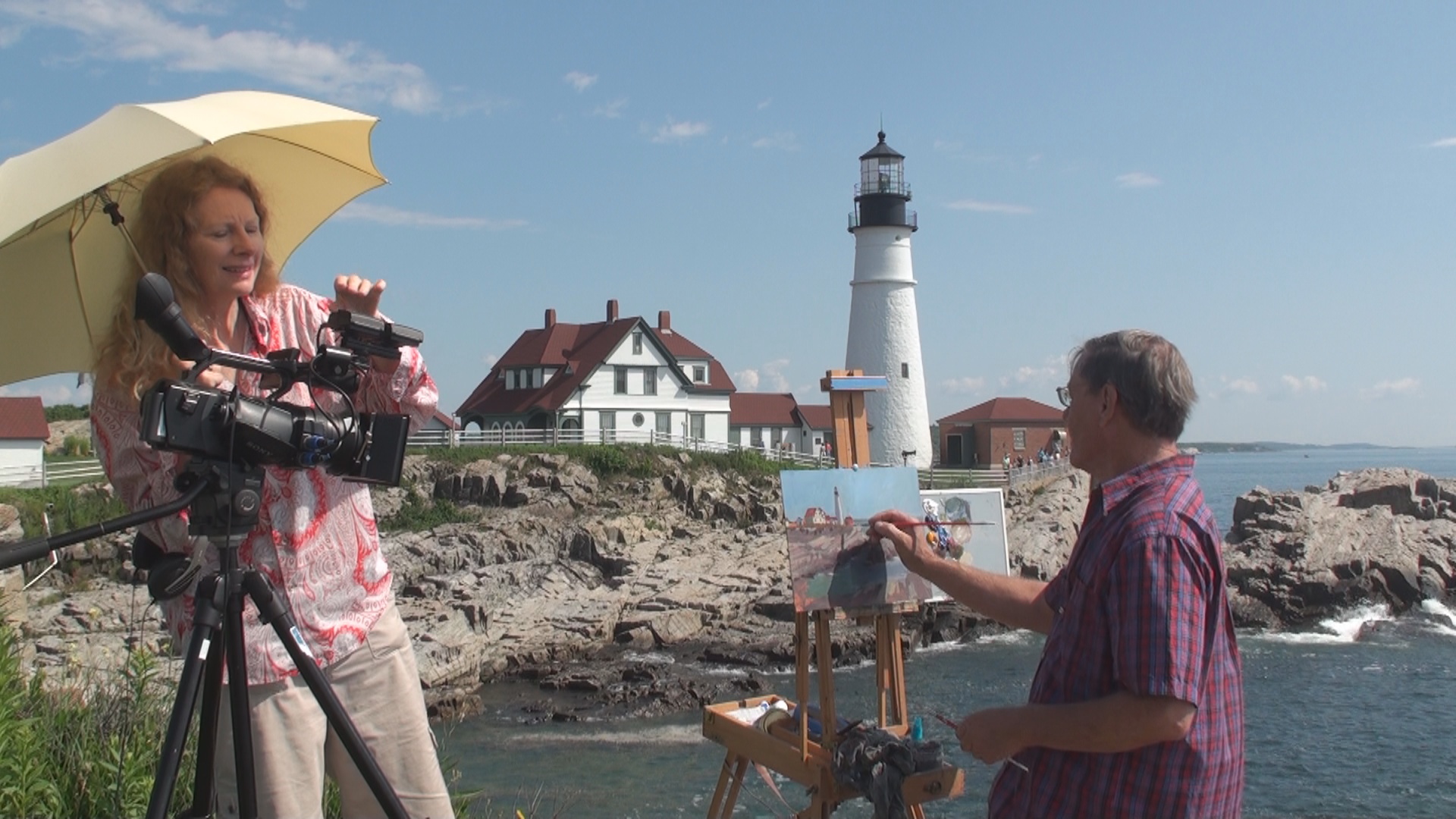 Roger and Sarah Bansemer of St. Augustine work on a shot for their public television program "Painting and Travel with Roger and Sarah Bansemer." They are near the Portland Light historic lighthouse in Maine. | Roger Bansemer