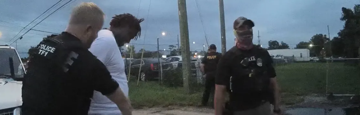 A screenshot from body-worn camera footage shows Jacksonville Sheriff’s Office police preparing to strip search Ronnie Reed. | Jacksonville Sheriff's Office