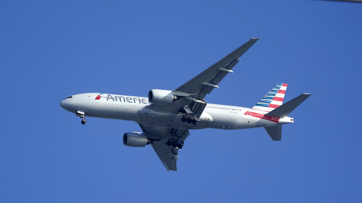 An American Airlines Boeing 777 is framed by utility wires as it prepares to land at Miami International Airport on Jan. 27, 2021. | Wilfredo Lee, AP file