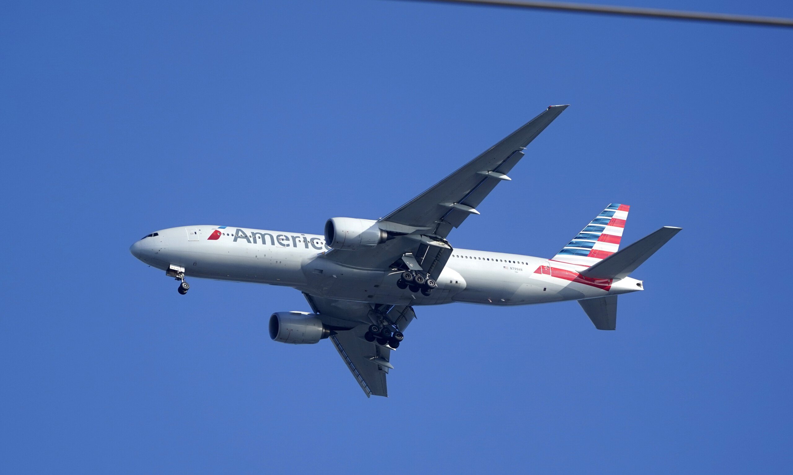An American Airlines Boeing 777 is framed by utility wires as it prepares to land at Miami International Airport on Jan. 27, 2021. | Wilfredo Lee, AP file