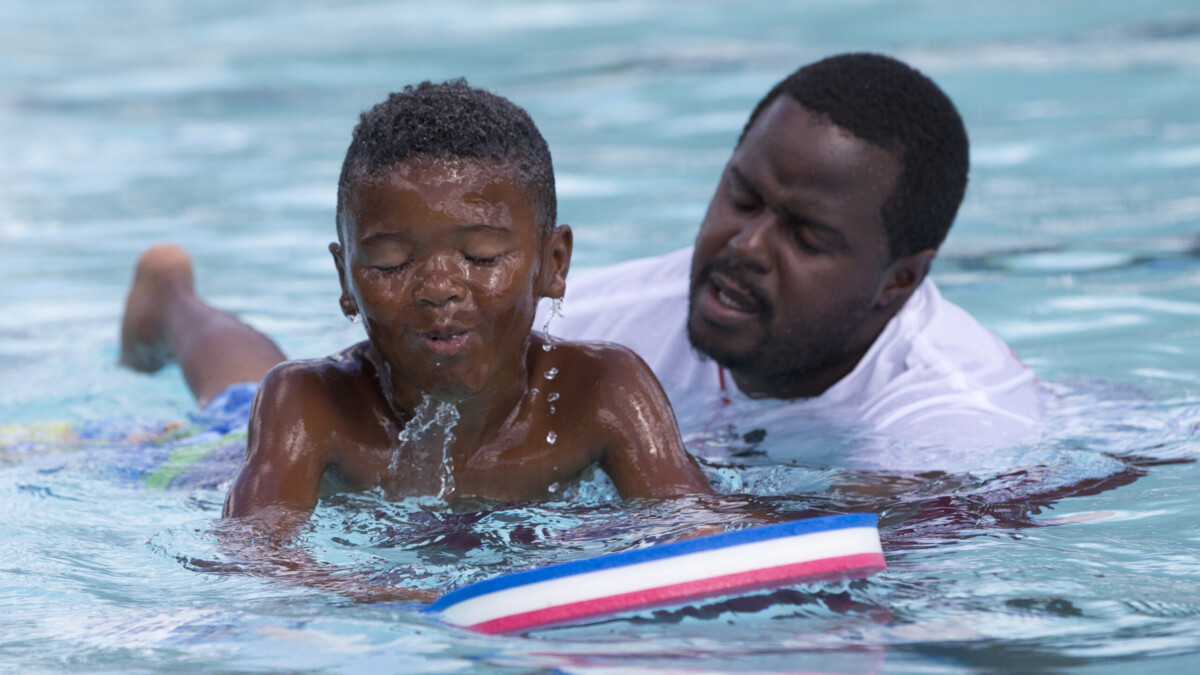 Lifeguard Darnell Cooper instructs Marquis Bryant, 7, during a swimming lesson June 18, 2015, at Gwen Cherry Park in Miami. | Wilfredo Lee, AP
