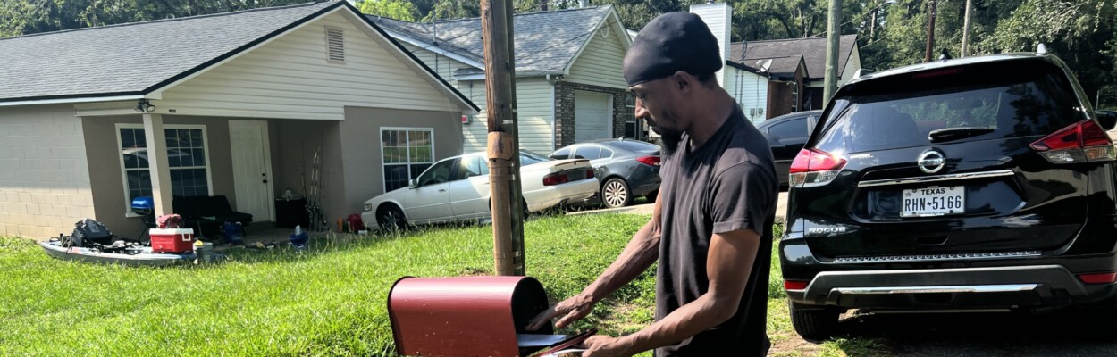 Tallahassee resident Julian Boise puts a completed voter registration form in his mailbox after volunteers with the Big Bend Voting Rights Project visited his home on the city's South Side on August, 19, 2023. | Valerie Crowder