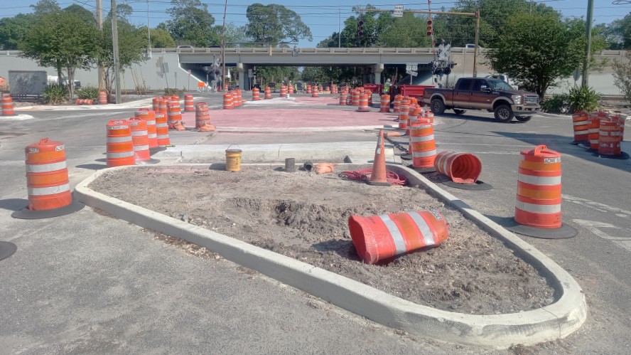 The new Edgewood Avenue roundabout and medians are under construction. The Roosevelt Boulevard overpass is shown in the background. | Florida Department of Transportation
