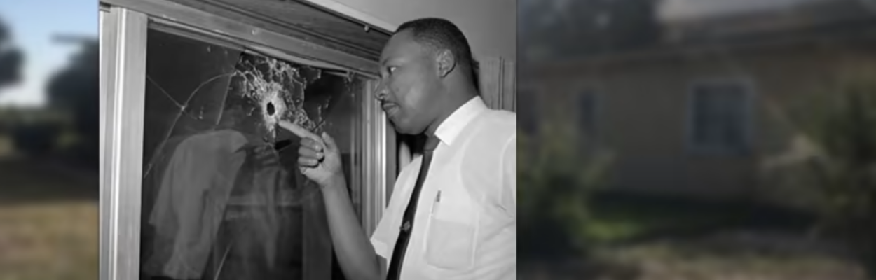 The Rev. Martin Luther King Jr. points to a bullet hole in a St. Johns County home in 1964. | Florida archives, News4Jax