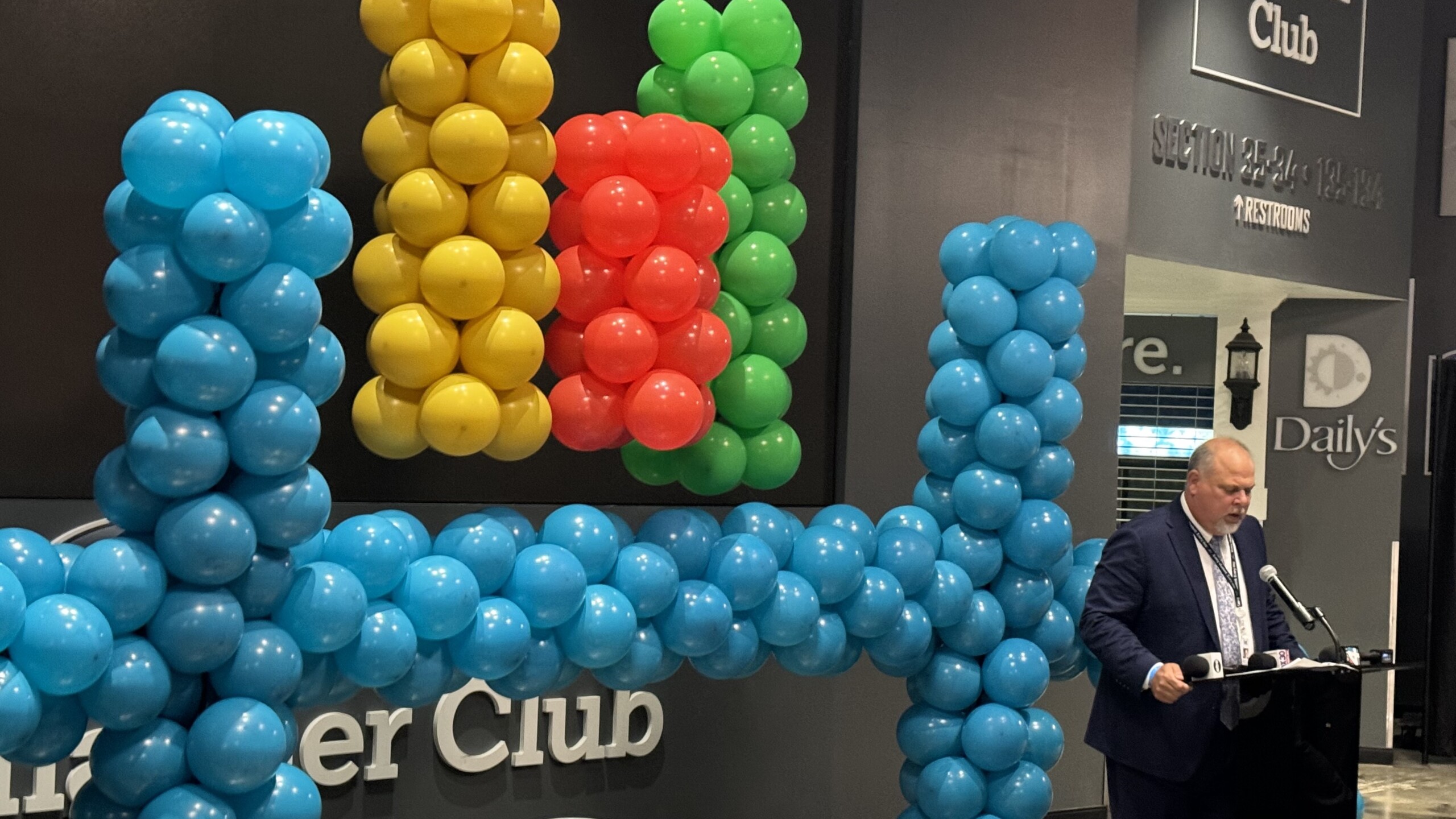 Christopher Bernier, Duval County's new schools superintendent, speaks during a forum May 13, 2024, at EverBank Stadium. The balloons form the school district's logo. | Megan Mallicoat, Jacksonville Today