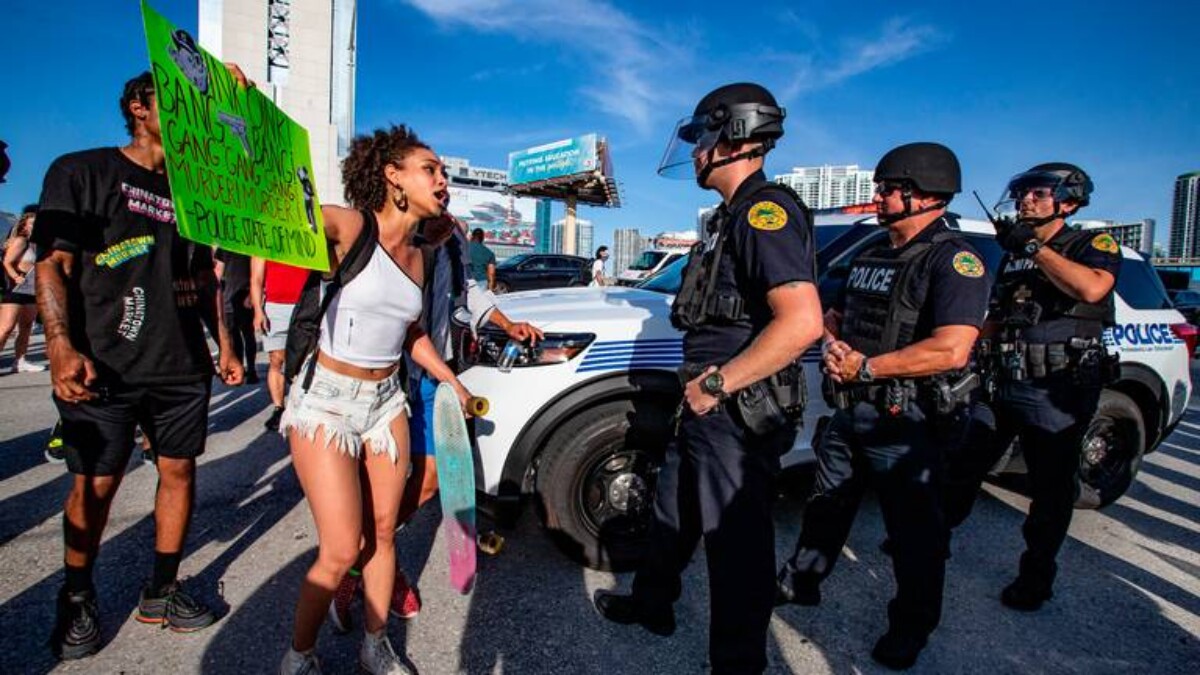 A protester confronts police in Miami. | Al Diaz, Miami Herald