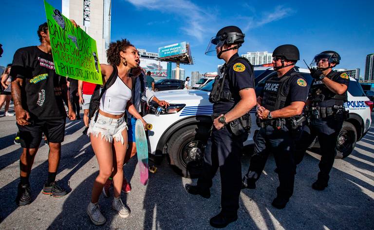 A protester confronts police in Miami. | Al Diaz, Miami Herald
