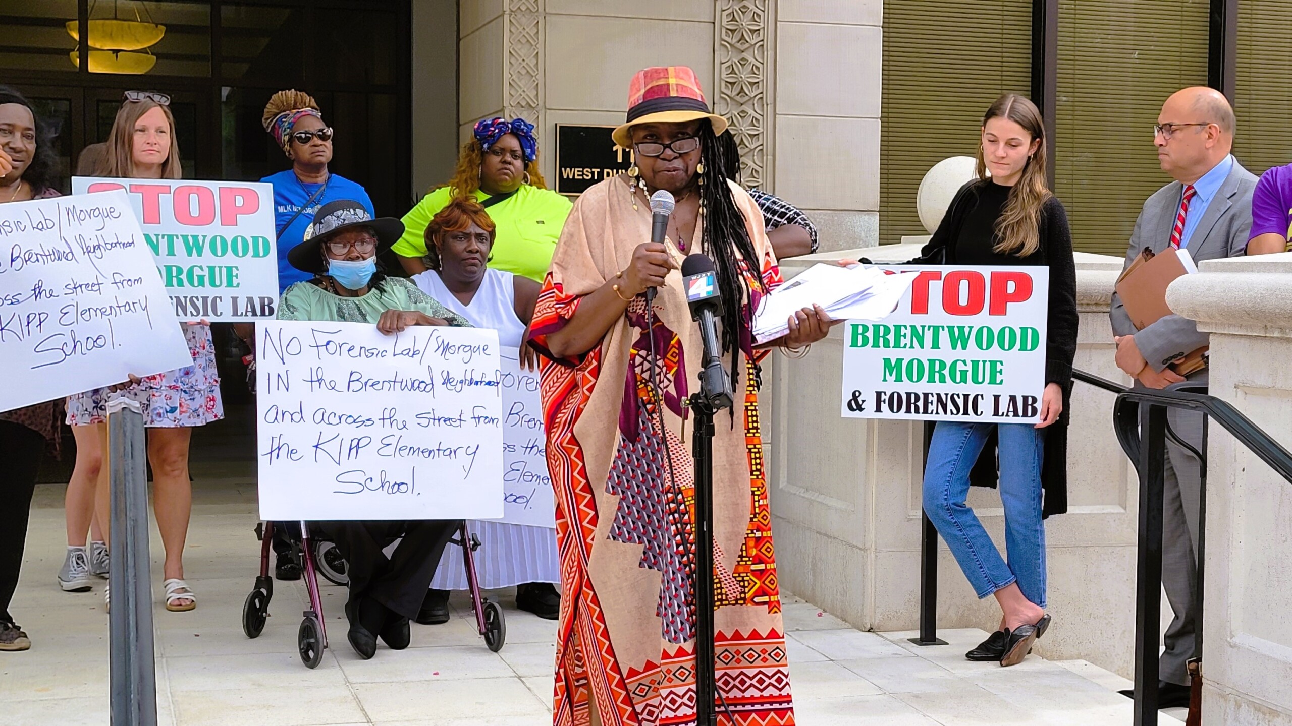 Metro Gardens Neighborhood Association President Lydia Bell announces a lawsuit against the city to stop construction of a new medical examiner's office in Brentwood. | Dan Scanlan, Jacksonville Today