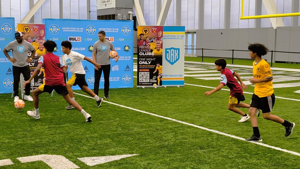 Sporting JAX co-owner Fred Taylor, left, and technical director Mauricio Ruiz watch a soccer demonstration by members of the All Nations Soccer Academy on Tuesday, June 25. | Dan Scanlan, Jacksonville Today