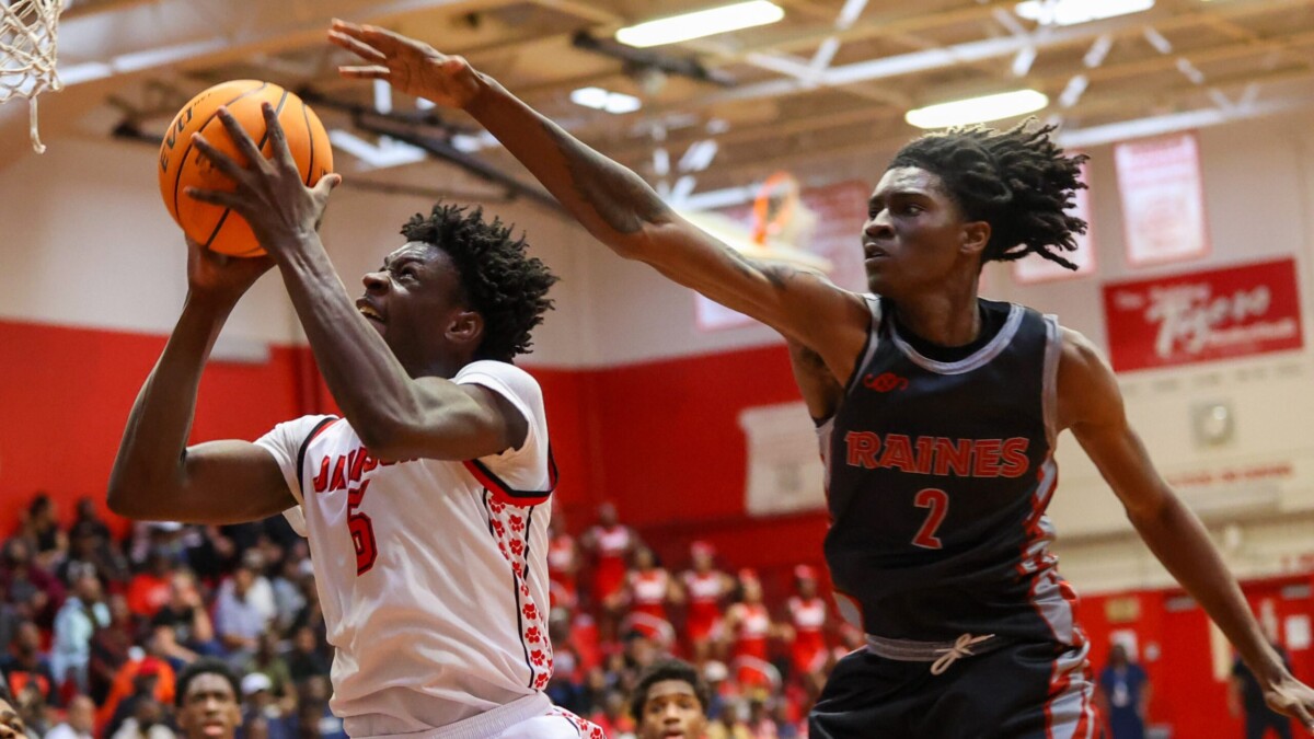 Andrew Jackson's TayVion Lawson finishes beyond the outstretched arm of Raines' forward Zion Kemp during the 2024 Gateway Conference boys basketball tournament final on Saturday, Jan. 27, 2024. Lawson and the Tigers won 57-48. | Will Brown, Jacksonville Today