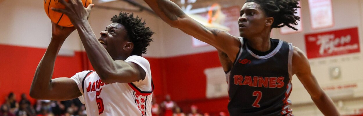 Andrew Jackson's TayVion Lawson finishes beyond the outstretched arm of Raines' forward Zion Kemp during the 2024 Gateway Conference boys basketball tournament final on Saturday, Jan. 27, 2024. Lawson and the Tigers won 57-48. | Will Brown, Jacksonville Today