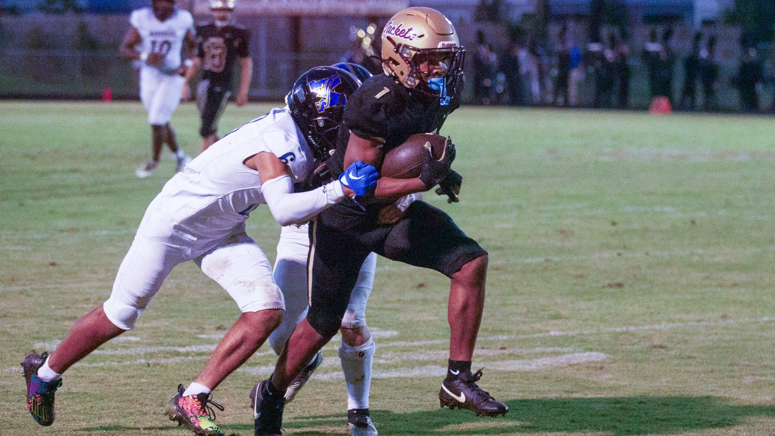 St. Augustine wide receiver Trenton Jones breaks through the attempted tackle of a pair of Menendez players on Sept. 15, 2023. | Will Brown, Jacksonville Today